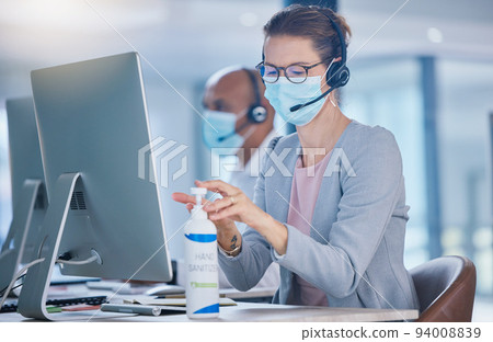 Sanitize, hygiene and compliance with covid19 regulations at call center with crm agent cleaning workstation. Woman working in customer service, making sure to leave desk fresh for the next operator Sanitize, hygiene and compliance with covid19 regulations at call center with crm agent cleaning workstation. Woman working in customer service, making sure to leave desk fresh for the next operator 94008839