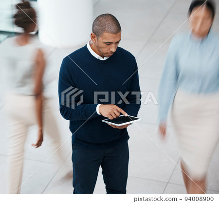Busy office with business man on tablet browsing, planning and scrolling for online research, mobile notes and digital ideas from above. Organized entrepreneur working on plan in a bustling workplace 94008900