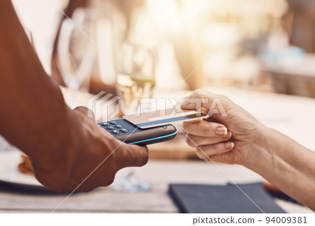 Credit card payment by a retail customer at a store paying using digital money or cash technology on portable machine. Security, safety and hands of sales worker helping woman shopping at a business 94009381
