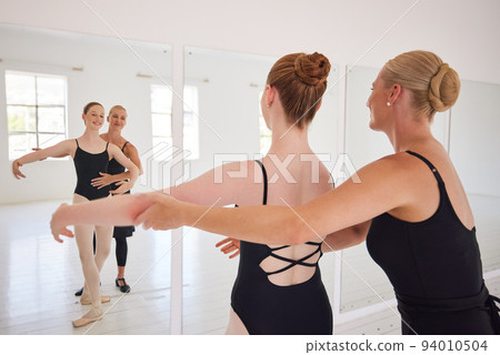 Training, fitness and ballet teacher teaching a ballerina a dance routine in a studio or center, happy and excited. Young performer learning rehearsal motion and posture, looking elegant and classy 94010504