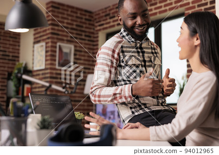 IT engineers couple developing encryption code on laptop, using terminal window with html script and binary code. Programming online application cloud server with firewall security. IT engineers couple developing encryption code on laptop, using terminal window with html script and binary code. Programming online application cloud server with firewall security. 94012965