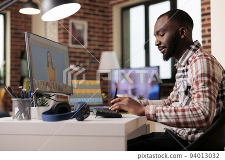 Media photographer using retouching software to edit photo, creating professional photography content. Freelancer artist editing image with color grading and retoucher interface. 94013032