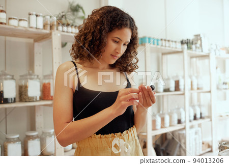 Health, organic and nutrition wellness female customer looking to buy healthy gluten free or vegan groceries. Young woman shopping in natural, ethical and sustainable food ingredients store 94013206