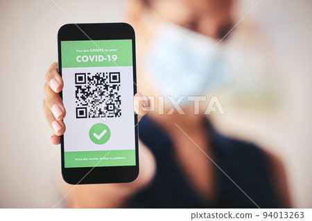 Covid passport, QR code and phone in the hand of a woman refugee or passenger ready for immigration and travel. Closeup of 5g mobile technology for safety during the global corona virus epidemic 94013263