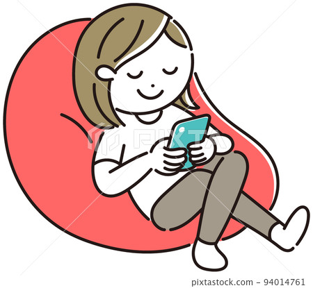 A woman relaxing while looking at her smartphone on a bead cushion 94014761
