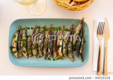 Grilled sardines with gremolata sauce on platter 94016326
