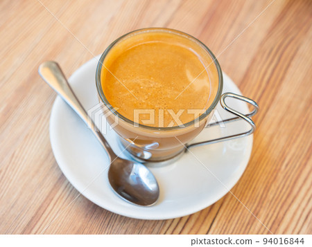 Image of cup of fresh coffee cortado on table 94016844