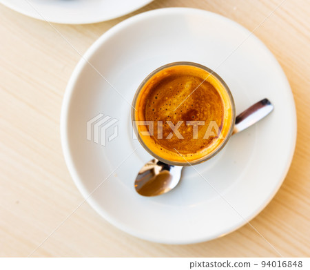 Mug of cortado served on table in cafe 94016848