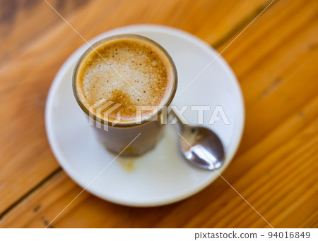 Image of cup of fresh coffee cortado on table 94016849