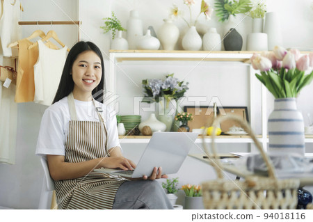 business owner smiling happily looking at the camera with be happy when reading news online. 94018116