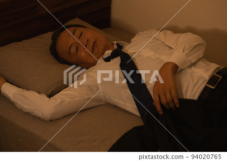 Image of a middle-aged man sleeping in a suit and a drunk man Image of a middle-aged man sleeping in a suit and a drunk man 94020765