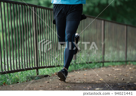 Feet of a man running Feet of a man running 94021441