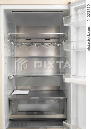 Opened empty refrigerator. Refrigerator open empty fridge inside interior. close up on empty fridge with door open. New clean refrigerator. Opened empty refrigerator. Refrigerator open empty fridge inside interior. close up on empty fridge with door open. New clean refrigerator. 94023210