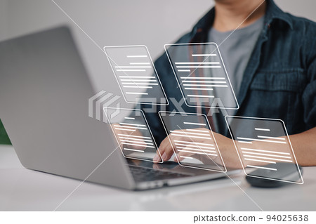 Laptop computer with electronic document icons, E-document management, an online documentation database, and the notion of a paperless workplace in mind for a businessman. 94025638
