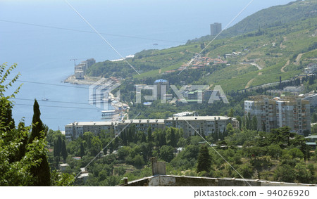 Southern coast of the Black Sea landscape. Sea mountains trees buildings. Place near resort town Gurzuf, Crimea 94026920