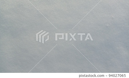 Beautiful sunny bright texture of snow in winter season. Background with natural snow texture, close-up view from above. Beautiful sunny bright texture of snow in winter season. Background with natural snow texture, close-up view from above. 94027065