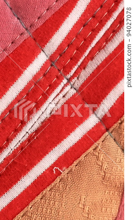 Colorful handmade textiles. Colored fabric patchwork background. 94027078