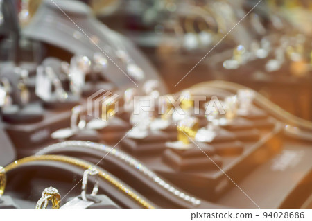 Abstract blur jewelry diamond shop with rings and necklaces luxury retail store window display Abstract blur jewelry diamond shop with rings and necklaces luxury retail store window display 94028686