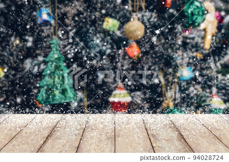 Christmas tree decorated abstract blur snow background with wood table Christmas tree decorated abstract blur snow background with wood table 94028724