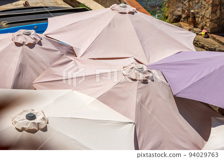 Close-up of a Group of Beach Umbrellas Seen From Above Close-up of a Group of Beach Umbrellas Seen From Above 94029763