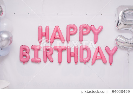 Pink garland of foil balloons "happy birthday" on holiday 94030499