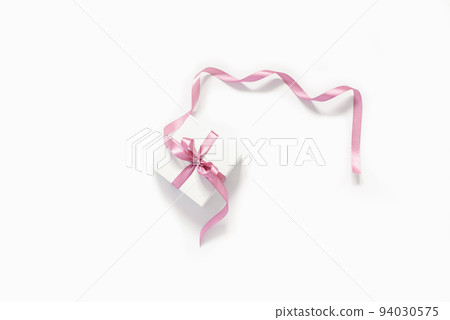 Gift white box with a pink bow satin ribbon on a white background. Birthday greeting card, Wedding, Christmas, March 8, mother's day Gift white box with a pink bow satin ribbon on a white background. Birthday greeting card, Wedding, Christmas, March 8, mother's day 94030575