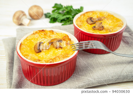 French Julienne casserole with chicken and mushroom in portion ramekin on white background 94030630