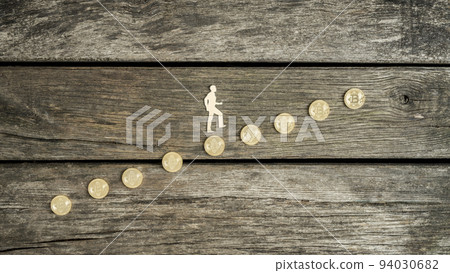 Man climbing a staircase of Bitcoins Man climbing a staircase of Bitcoins 94030682