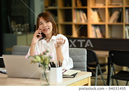 Asian woman financial advisor having phone conversation, negotiations with business partner Asian woman financial advisor having phone conversation, negotiations with business partner 94031495