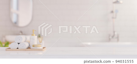 Elegance white marble bathroom tabletop with copy space for product display over blurred bathroom Elegance white marble bathroom tabletop with copy space for product display over blurred bathroom 94031555