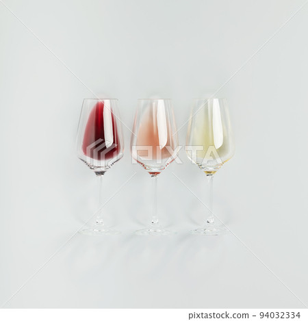 Flat-lay of red, rose and white wine in glasses on white background 94032334