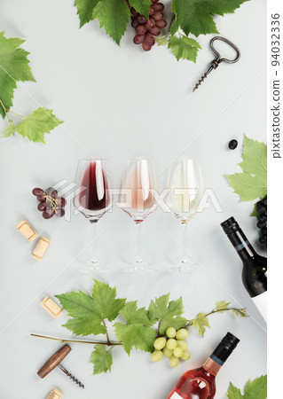 Flat-lay of red, rose and white wine in glasses on white background 94032336