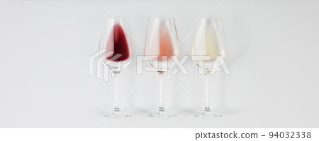 Flat-lay of red, rose and white wine in glasses on white background, banner 94032338