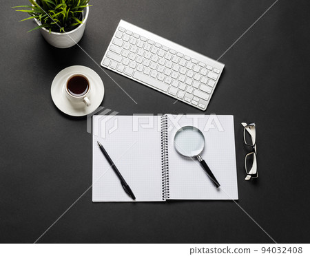 Top view of modern workplace with green plant. 94032408