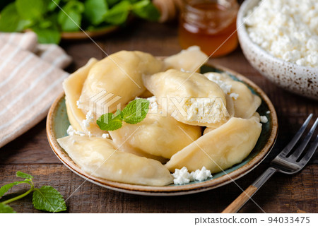 Traiditional Ukrainian Pierogi, Vareniky stuffed with cottage cheese Traiditional Ukrainian Pierogi, Vareniky stuffed with cottage cheese 94033475