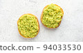Vegan Toast with mashed avocado on grey 94033530