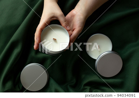 Soy candles in metal cans, handmade modern hobby , harmless coconut wax candles without paraffin on green background  94034091