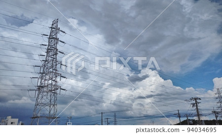 Cumulonimbus tower covering the blue sky 94034695