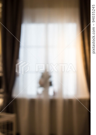 Abstract and blurry image of window with curtains with fir tree Abstract and blurry image of window with curtains with fir tree 94035245