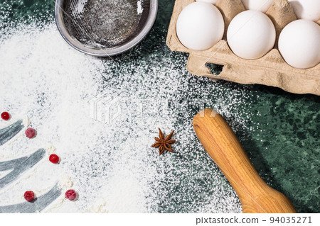flour, berries and anise star spices as a decoration and rolling pin, eggs, strainer flour, berries and anise star spices as a decoration and rolling pin, eggs, strainer 94035271