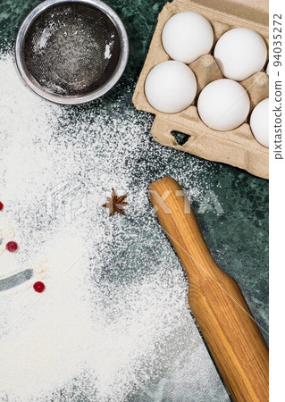 flour, berries and anise star spices as a decoration and rolling pin, eggs, strainer flour, berries and anise star spices as a decoration and rolling pin, eggs, strainer 94035272