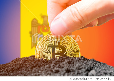 Legalization of bitcoins in Moldova. Planting a Bitcoin in the ground against the background of the flag of Moldova. Moldova - investment in cryptocurrency Legalization of bitcoins in Moldova. Planting a Bitcoin in the ground against the background of the flag of Moldova. Moldova - investment in cryptocurrency 94036319