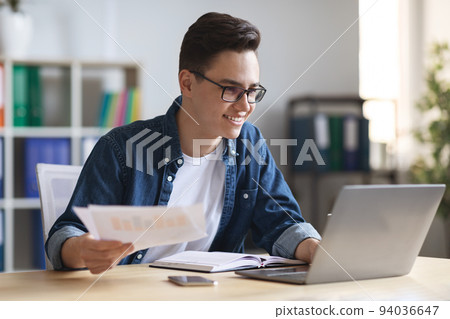 Office Work. Portrait Of Smiling Young Entrepreneur Working With Papers And Laptop 94036647