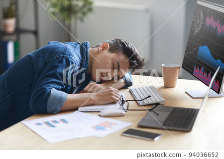 Portrait Of Tired Young Male Employee Sleeping At Work Portrait Of Tired Young Male Employee Sleeping At Work 94036652