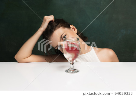 Modern art photography. Funny weird girl's face through glass of water. Object distortion, optical illusion. Minimalistic contemporary art. Modern art photography. Funny weird girl's face through glass of water. Object distortion, optical illusion. Minimalistic contemporary art. 94039333