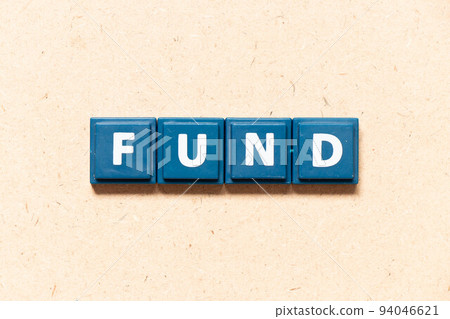 Tile letter in english word fund on wood background Tile letter in english word fund on wood background 94046621