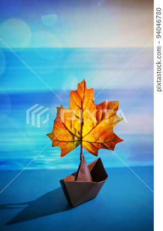 Paper Boat With A Maple Leaf On A Pond 94046780