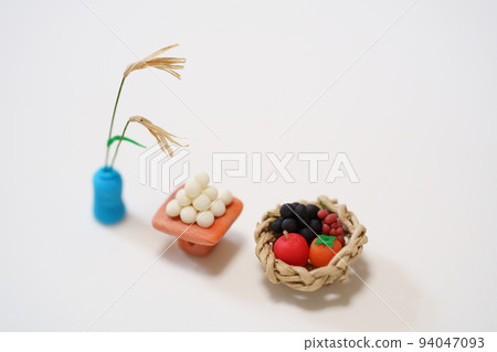 Miniature moon-viewing offerings Japanese pampas grass, moon-viewing dumplings, and fruit 94047093