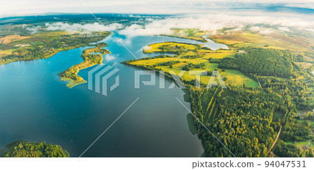 Lyepyel District, Lepel Lake, Beloozerny District, Vitebsk Region. Aerial View Of Residential Area With Houses In Countryside. Morning Fog Above Lepel Lake. Top View Of European Nature From High Lyepyel District, Lepel Lake, Beloozerny District, Vitebsk Region. Aerial View Of Residential Area With Houses In Countryside. Morning Fog Above Lepel Lake. Top View Of European Nature From High 94047531