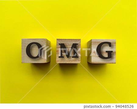 Alphabets of OMG on wooden blocks with yellow background. Alphabets of OMG on wooden blocks with yellow background. 94048526
